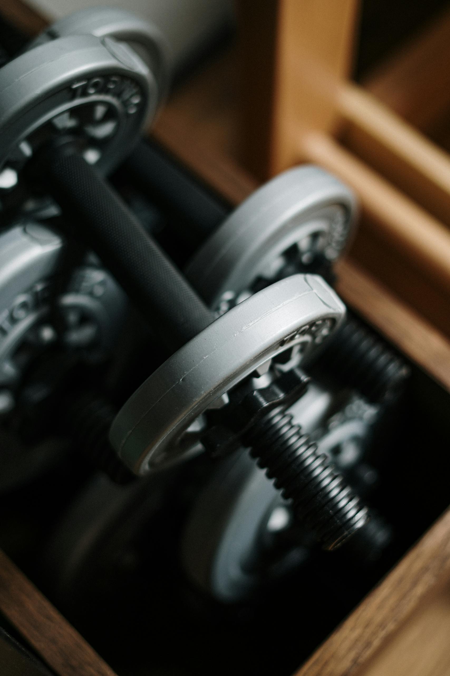 Detailed shot of dumbbells in a gym, emphasizing fitness equipment.